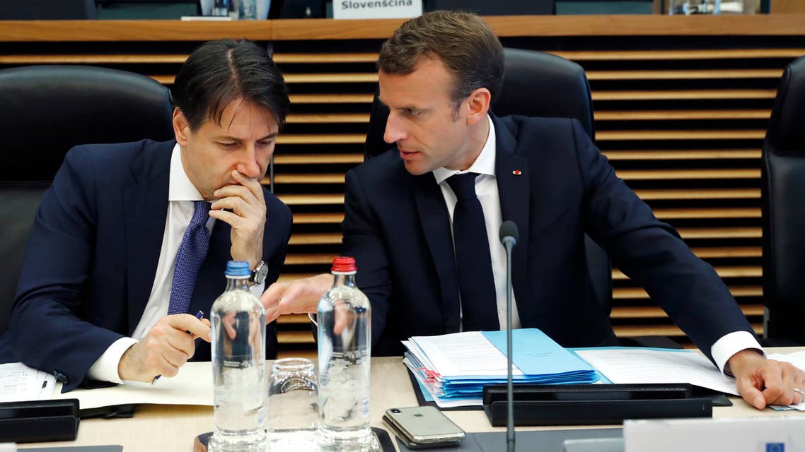 Italian Prime Minister Giuseppe Conte (L) speaks with French President Emmanuel Macron during an informal EU summit on migration at the EU commission in Brussels on June 24, 2018. EU leaders headed to Brussels for emergency talks over migration as Italy's new populist cabinet turned away another rescue ship, vowing no longer to shoulder Europe's migrant burden.