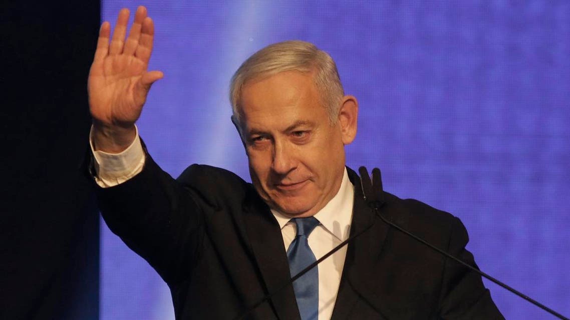 Israeli Prime Minister Benjamin Netanyahu waves as he addresses supporters at his Likud party's electoral campaign headquarters in the coastal city of Tel Aviv early on September 18, 2019. (AFP)