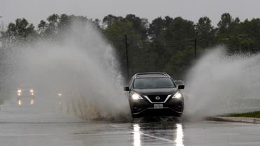 A car drives through floodwaters from Tropical Depression Imelda on Septmber 18, 2019, in Houston. (AP)