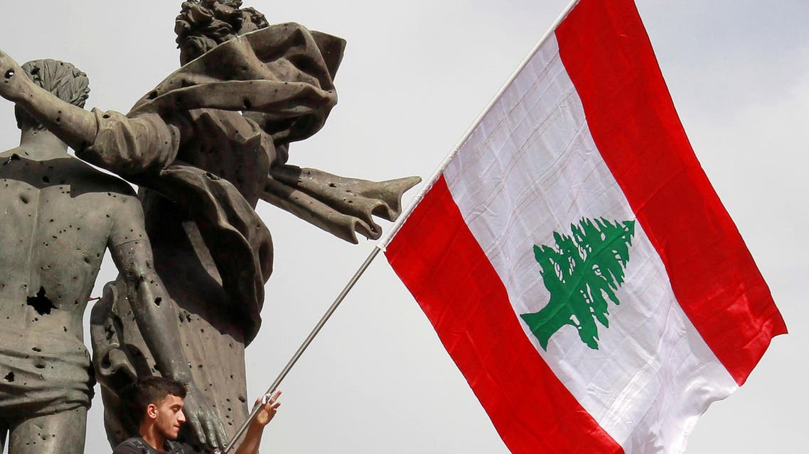 Lebanon flag waving protestor martyr's square Beirut - Reuters