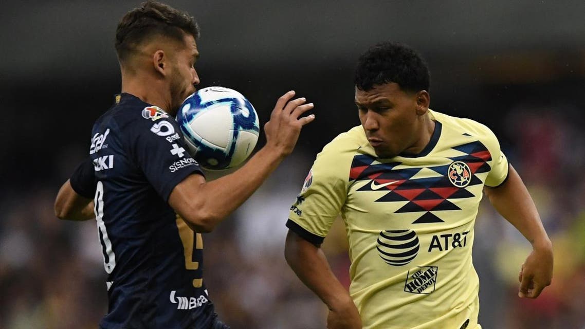 America’s Colombian forward Roger Martinez (R) battles the ball with Pumas’ Argentinian defender Nicolas Freire during the Mexican Apertura football tournament match at the Azteca stadium in Mexico City, on September 14, 2019. (AFP)