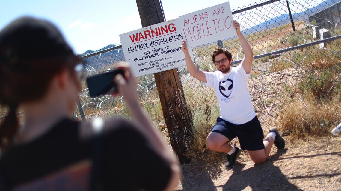 A man poses at an entrance gate to the Nevada Test and Training Range, located near Area 51, on September 20, 2019, near Rachel, Nevada. (AFP)