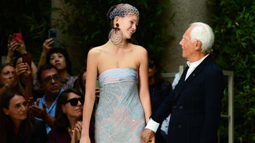 Italian fashion designer Giorgio Armani (R) acknowledges applause following the presentation of his Women’s Spring Summer 2020 collection in Milan on September 21, 2019. (AFP)