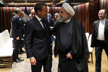French President Emmanuel Macron (L) and Iranian President Hassan Rouhani shake hands after a meeting at the United Nations headquarters on September 23, 2019, in New York. (AFP)