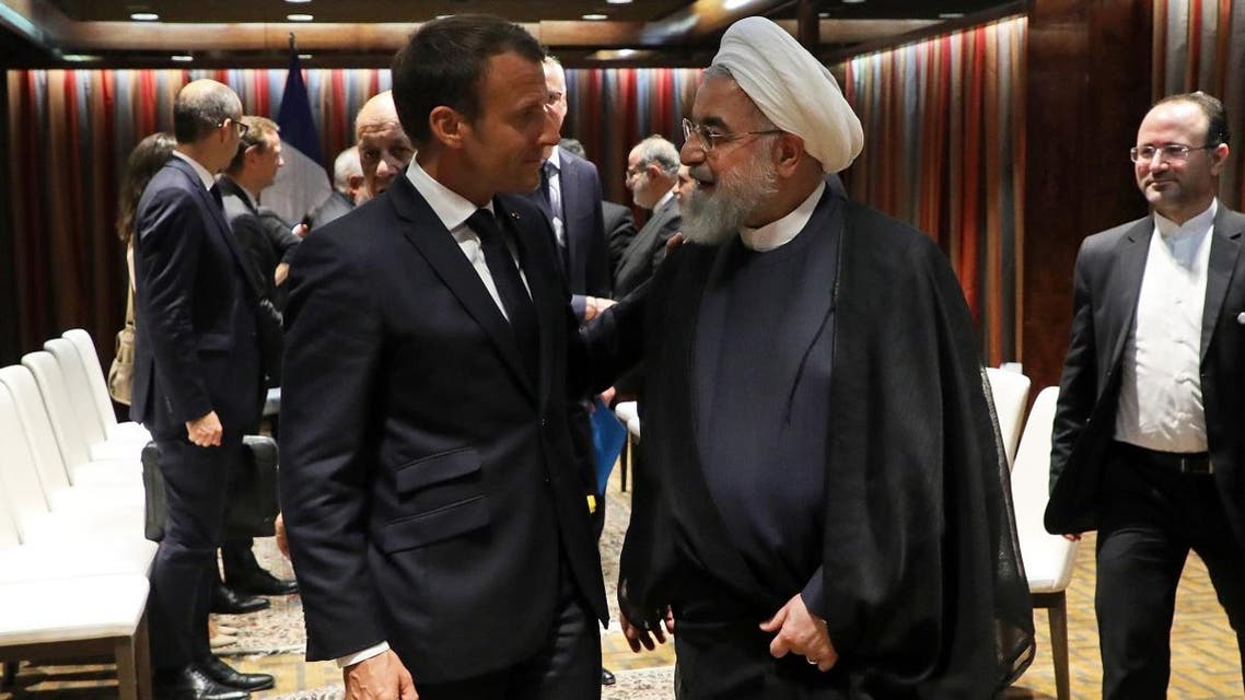 French President Emmanuel Macron (L) and Iranian President Hassan Rouhani shake hands after a meeting at the United Nations headquarters on September 23, 2019, in New York. (AFP)