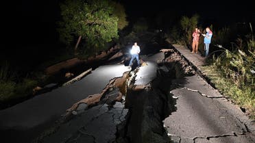 A news cameraman films a damaged road following an earthquake on the outskirts of Mirpur on September 24, 2019. (AFP)