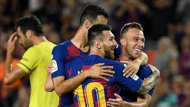 Barcelona's Brazilian midfielder Arthur (R) is congratulated by teammate Barcelona's Argentine forward Lionel Messi (C) after scoring the second goal during the Spanish league football match between FC Barcelona and Villarreal CF at the Camp Nou stadium in Barcelona, on September 24, 2019. (AFP)