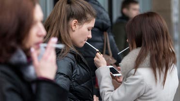 Women smoke cigarettes at a shopping center in Moscow, Russia, Tuesday, Feb. 12, 2013. (AP)