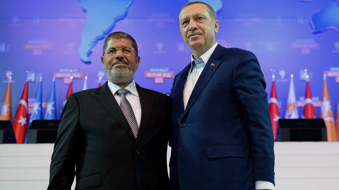 FILE - In this Sept. 30, 2012 file photo, Turkey's Prime Minister Recep Tayyip Erdogan, right, and Egyptian President Muhammed Morsi attend the congress of Turkey's ruling Justice and Development Party in Ankara, Turkey. Turkey, which had formed an emerging alliance with Egypt's ousted Islamist leader Morsi, on Thursday, July 4, 2013, slammed democratically elected leader's overthrow by the military as “unacceptable” and called for his release from house arrest as Erdogan's Islamic-rooted government has been watching developments in Egypt with concern.(AP Photo/File)