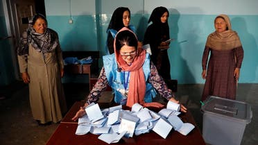 An Afghan election commission worker prepares ballot papers for counting of the presidential election in Kabul, Afghanistan. (Reuters)