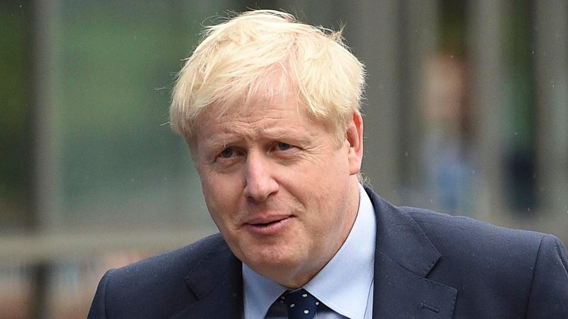 Britain's Prime Minister Boris Johnson walks outside the Manchester Central convention complex in Manchester, northwest England on September 29, 2019, on the first day of the annual Conservative Party conference. (AFP)