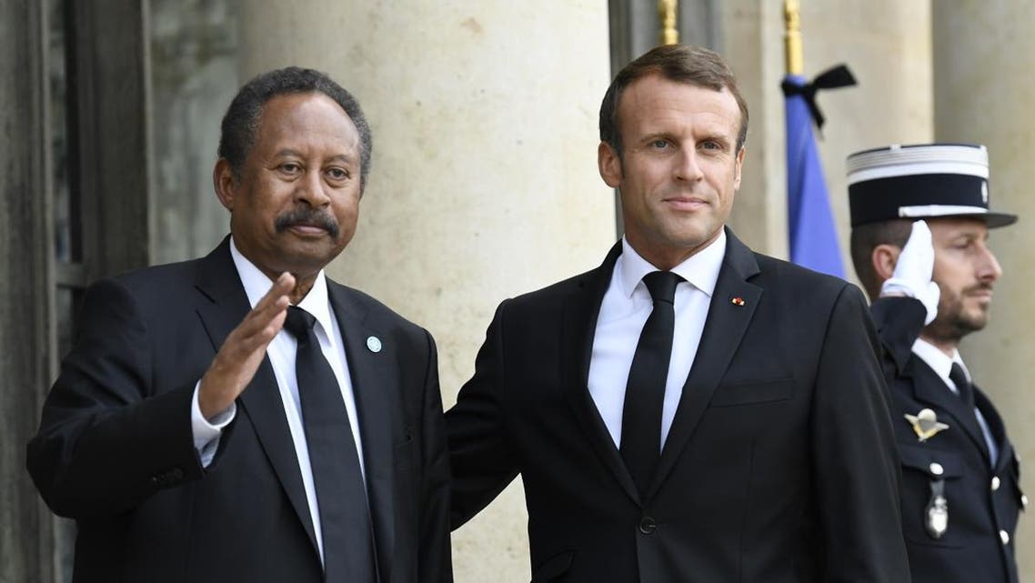 French President Emmanuel Macron (R) poses with Sudan's Prime Minister Abdalla Hamdok ahead of a meeting at The Elysee Presidential Palace in Paris on September 30, 2019. (AFP)
