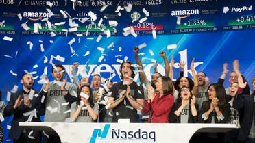 In this Jan. 16, 2018 file photo, Adam Neumann, center, co-founder and CEO of WeWork, attends the opening bell ceremony at Nasdaq in New York. (AP)