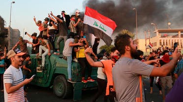 Anti-government protesters take over an armored vehicle before they burn it during a demonstration in Baghdad, Iraq, on Oct. 3, 2019. (AP)