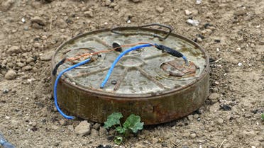 This picture taken on March 24, 2019 shows a discarded landmine lying on the ground in the village of Baghouz in Syria's eastern Deir Ezzor province near the Iraqi border, a day after IS group's caliphate was declared defeated by the US-backed Kurdish-led Syrian Democratic Forces (SDF).