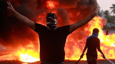 An anti-government protester flashes the victory sign during a demonstration in Baghdad, Iraq, on October 3, 2019. (AP)