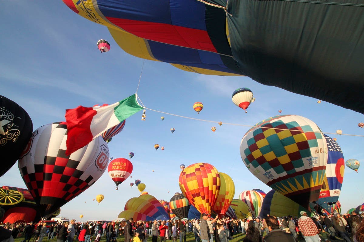 In this October 2, 2011, file photo, thousands of spectators mingle among inflating hot air balloons at the 40th Albuquerque International Balloon Fiesta in Albuquerque. (AP)