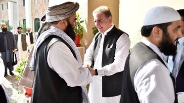Pakistan’s Foreign Minister Shah Mehmood Qureshi (center), receives members of Taliban delegation in Islamabad on October 3, 2019. (AP)