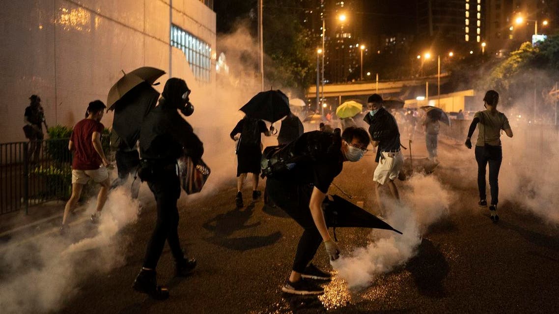 Protesters run away after police fired tear gas during a demonstration near Tai Koo station in Hong Kong, on Oct. 3, 2019. (AP)