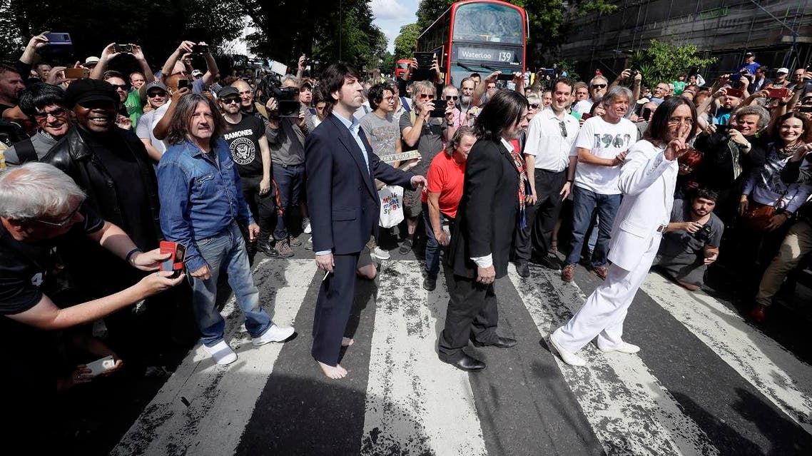 Fans dressed as lookalikes walk acrossFans dressed as lookalikes walk across the Abbey Road zebra crossing on the 50th anniversary of British pop musicians The Beatles doing it for their album cover of ‘Abbey Road’ in St Johns Wood in London. (AP) the Abbey Road zebra crossing on the 50th anniversary of British pop musicians The Beatles doing it for their album cover of 'Abbey Road' in St Johns Wood in London. (AP)