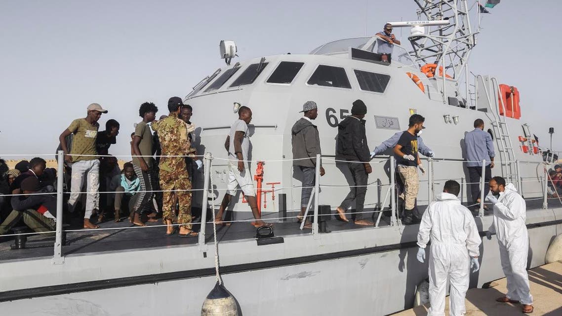 Rescued migrants walk off a coast guard boat in the city of Khoms, around 120 kilometers east of Tripoli, Libya, on October 1, 2019. (AP)