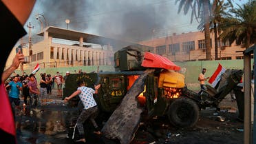 Anti-government protesters burn an armored vehicle belonging to the Federal Police Rapid Response Forces during a protest in Baghdad, Iraq, Thursday, Oct. 3, 2019. (AP)