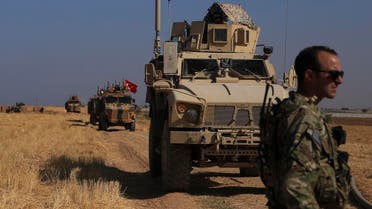 Turkish and American armored vehicles patrol as they conduct joint ground patrol in the so-called “safe zone” on the Syrian side of the border with Turkey, near the town of Tal Abyad, northeastern Syria, on October 4, 2019. (AP)