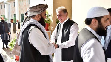 In this photo released by the Foreign Office, Pakistan's Foreign Minister Shah Mehmood Qureshi, center, receives members of Taliban delegation at the Foreign Office in Islamabad, Pakistan, Thursday, Oct. 3, 2019. (AP)