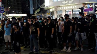 Two protesters charged in first use of Hong Kong’s new mask ban