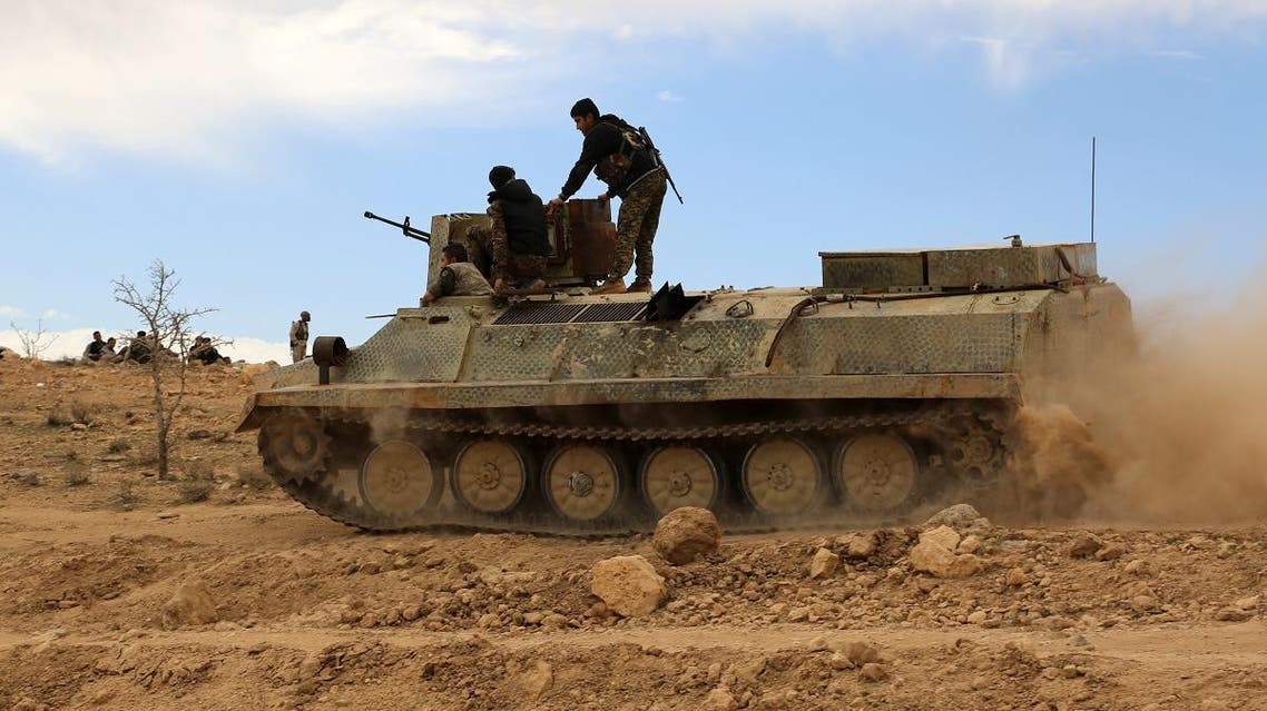Fighters from the Syrian Democratic Forces (SDF) sit atop an armoured personnel carrier on the outskirts of the town of al-Shadadi in the northeastern Syrian province of Hasakah. (File photo: AFP)