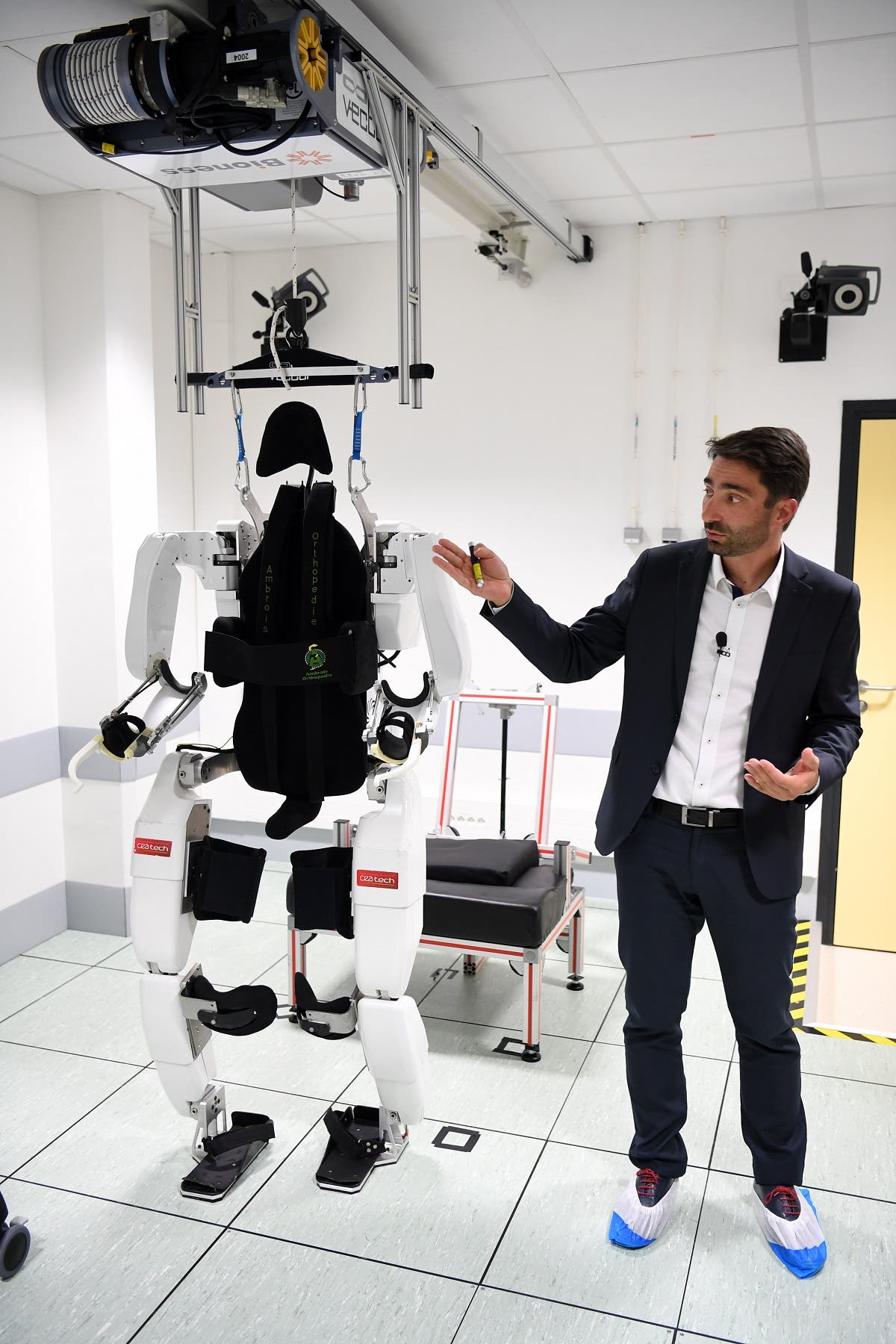 French project manager Gullaume Charvet presents the brain-controlled exoskeleton that allowed a disabled patient to walk again at the biomedical research center Clinatec in Grenoble on October 7, 2019. (AFP)
