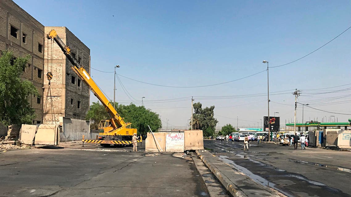 Iraqi security forces remove concrete blast walls that were cutting the streets in the protest site area of Baghdad, a day after calm was restored in the Iraqi capital, on October 8, 2019. (AP)
