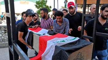 Mourners carry the Iraqi flag-draped coffin of a protester, who was killed amidst clashes in a demonstration, during his funeral in the central Iraqi city of Najaf on October 4, 2019. (AFP)