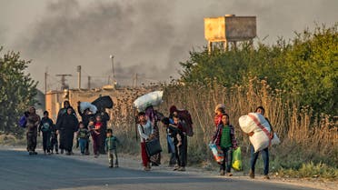 Civilians flee with their belongings amid Turkish bombardment on Syria’s northeastern town of Ras al-Ain in the Hasakeh province along the Turkish border on October 9, 2019. (AFP)