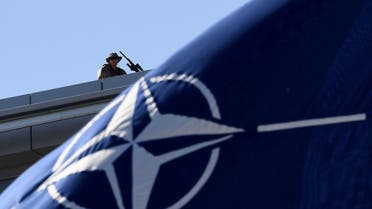 A military personnel stands guard on top of the roof during the NATO (North Atlantic Treaty Organization) summit ceremony at the NATO headquarters, in Brussels. (AFP)