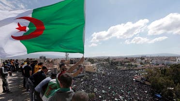 A demonstrator holds an Algerian flag during a protest in Bordj Bou Arreridj, east of Algiers. (AP)