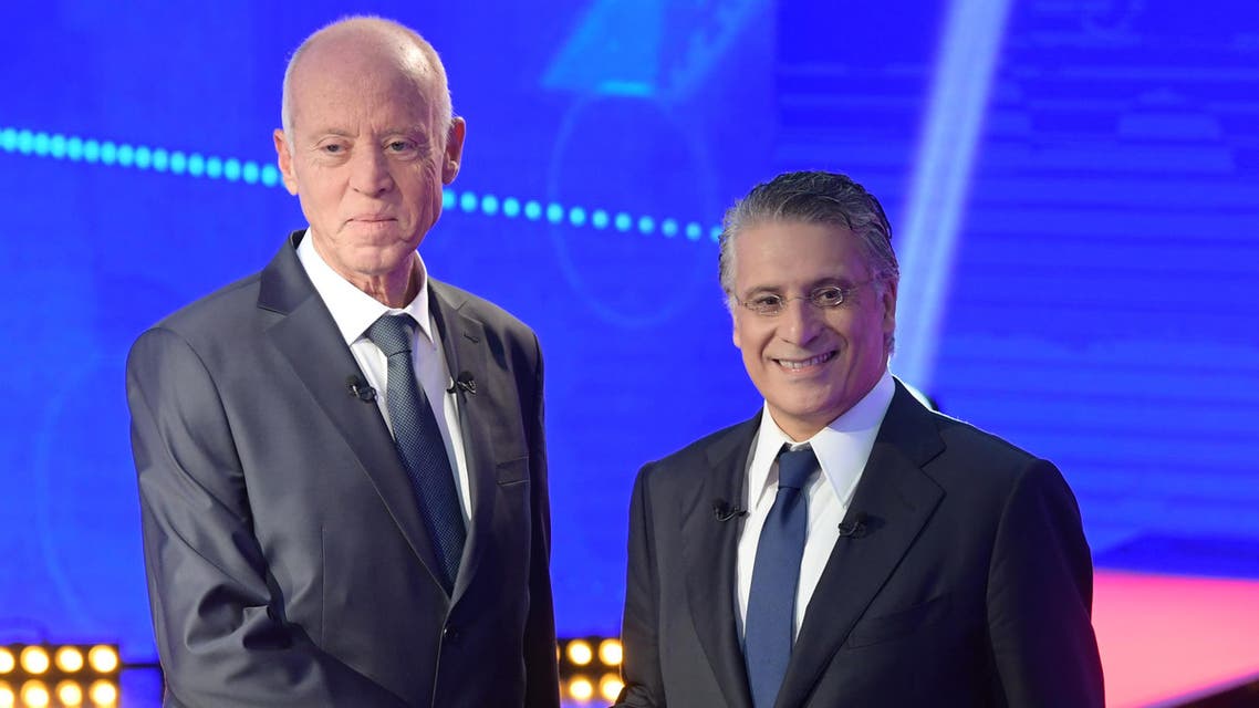 Tunisia's presidential candidates Kais Saied (L), 61, an independent conservative academic, and business tycoon Nabil Karoui (R), 56, attend a debate before the second round of the presidential elections on October 11, 2019 in Tunis. (AFP)