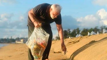In this handout photo provided by the Indian Prime Minister’s Office, Prime Minister Narendra Modi picks trash from a beach in Mamallapuram, India. (AP)
