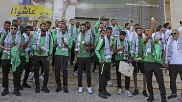 Members of Saudi Arabia’s national football team are welcomed in the Palestinian city of Ramallah on October 13, 2019 upon the team’s arrival in the occupied Palestinian territories where they will play for the first time their match in the Asian qualifiers for the 2022 World Cup against Palestine in two days. (AFP)