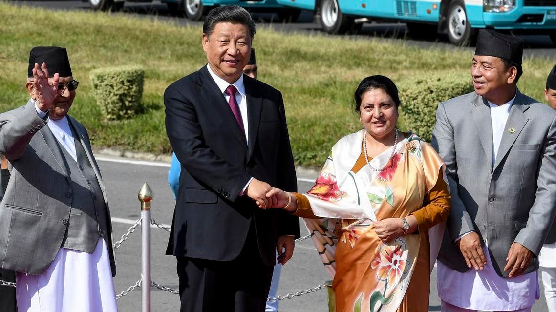 Nepal’s President Bidhya Devi Bhandari (2R) and China’s President Xi Jinping (2L) shake hands, wrapping up his two-day visit to Nepal, in Kathmandu on October 13, 2019. (AFP)