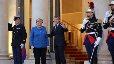 French President Emmanuel Macron (3rdL) and German Chancellor Angela Merkel (2ndL) pose upon her arrival at the Elysee Palace for a working dinner ahead of the EU summit in Paris on October 13, 2019. (AFP)