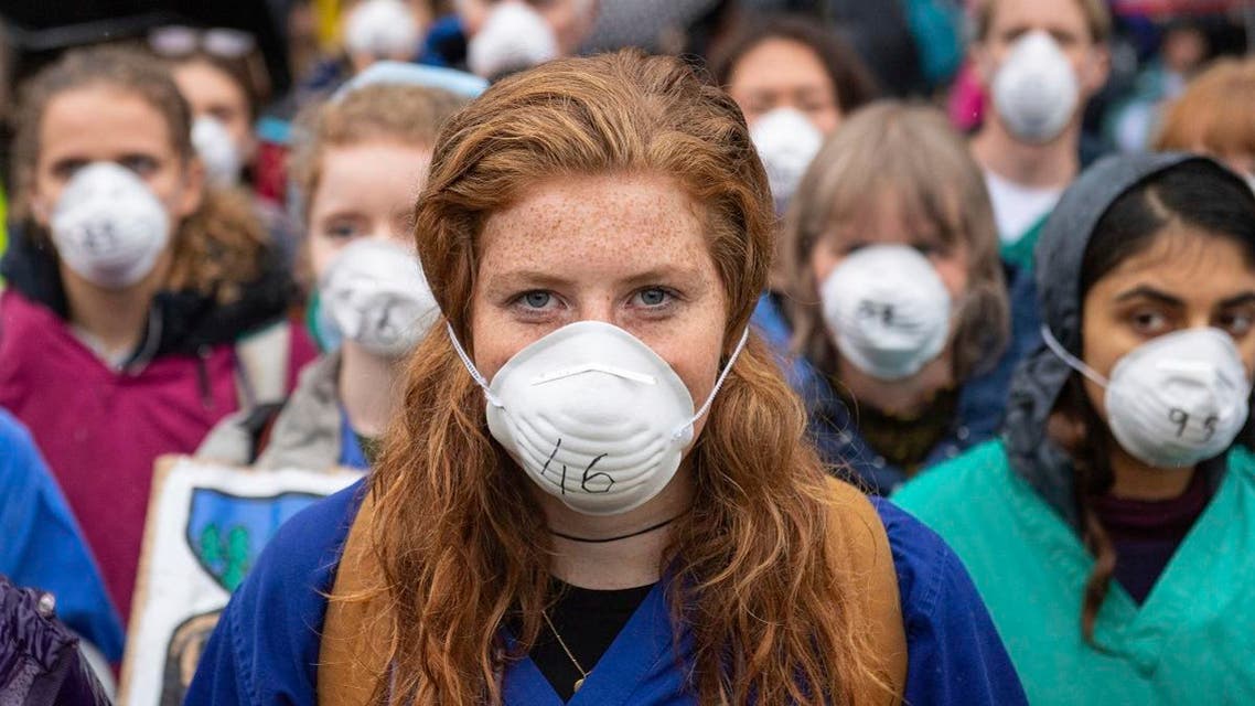 Doctors gather to protest in support of Extinction Rebellion (XR) at Jubilee Gardens, London. (AP)