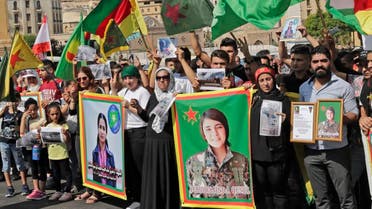 Kurdish protesters wave their national flags and hold photos of Kurdish political leader Hevrin Khalaf (L). (File photo: AFP)