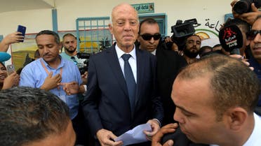 Tunisia’s presidential candidate Kais Saied leaves a polling station after casting his ballot in the capital Tunis on October 13, 2019, during the second round of the presidential election. (AFP)