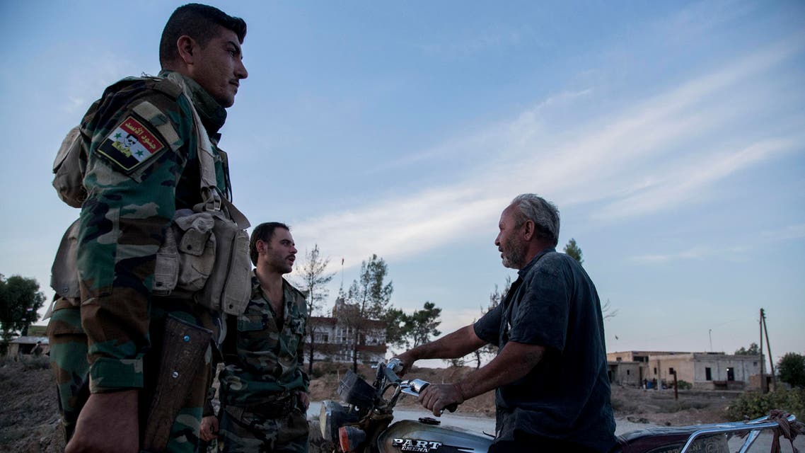 Syrian government troops man a checkpoint town of Tal Tamr in northeast Syria, on October 14, 2019. (AP)