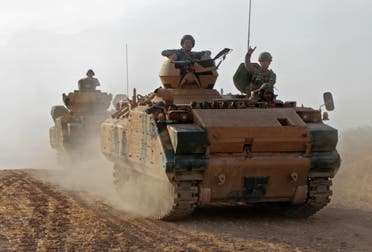 Turkish soldiers are trasported in armored personnel carriers through the town of Tukhar, north of Syria’s northern city of Manbij, on October 14, 2019, as Turkey and it’s allies continues their assault on Kurdish-held border towns in northeastern Syria. (AFP)