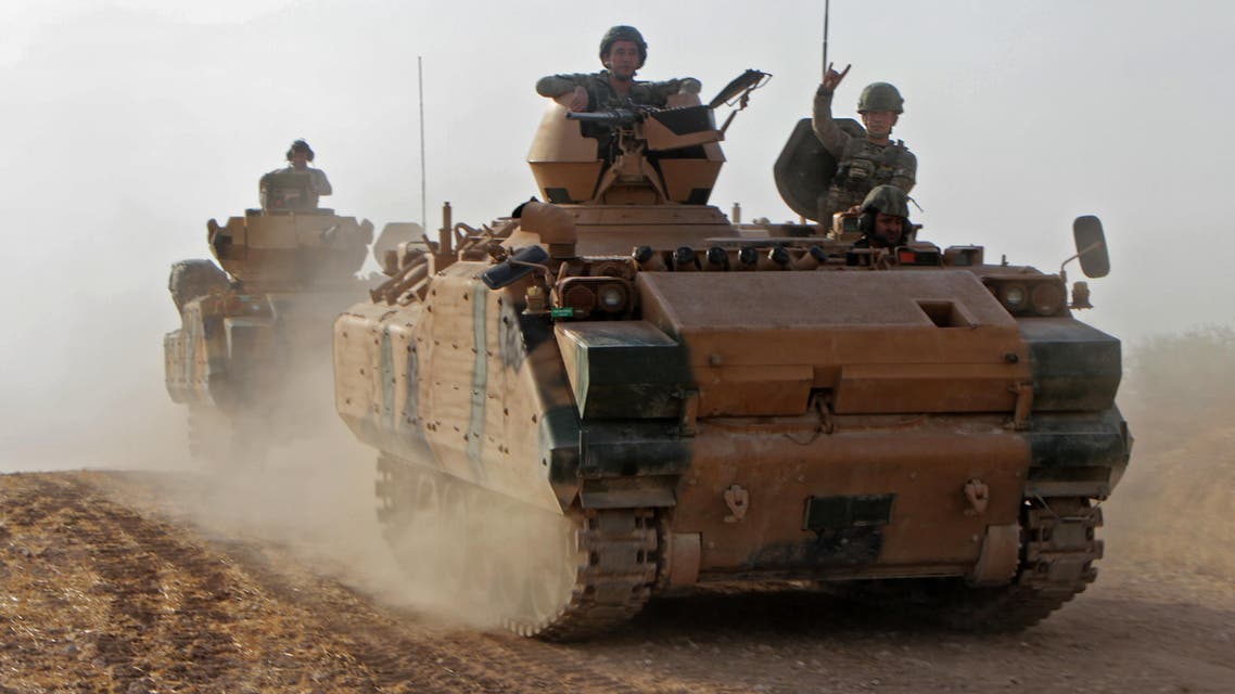 Turkish soldiers are trasported in armored personnel carriers through the town of Tukhar, north of Syria’s northern city of Manbij, on October 14, 2019, as Turkey and it’s allies continues their assault on Kurdish-held border towns in northeastern Syria. (AFP)