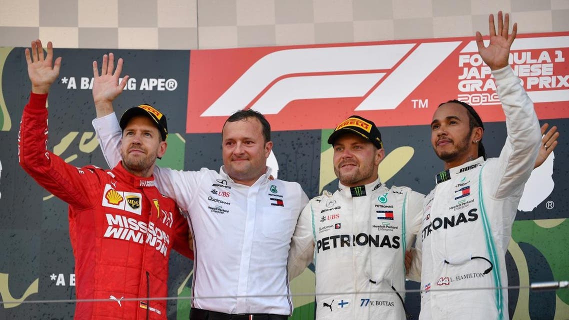 Mercedes’ Valtteri Bottas (2nd R) celebrates his victory on the podium with second-placed Ferrari’s Sebastian Vettel (L) and third-placed Mercedes’ Lewis Hamilton (R) at the end of the Japanese Grand Prix final at Suzuka on October 13, 2019. (AFP)