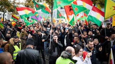 Protesters wave flags as they take part in a rally in Berlin, on October 12, 2019 to support Kurdish militants as Turkey kept up its assault on Kurdish-held border towns in northeastern Syria on the fourth day of an offensive that is drawing growing international condemnation, even from Washington. (AFP)