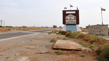 A sign indicating the beginning of the northern Syrian province of Raqa is pictured on October 16, 2019 as Syrian regime forces (unseen) deployed there at the Tabqa air base. (AFP)